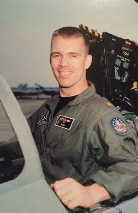 Jeffery Lay, callsign Easy, beside his F-14 Tomcat